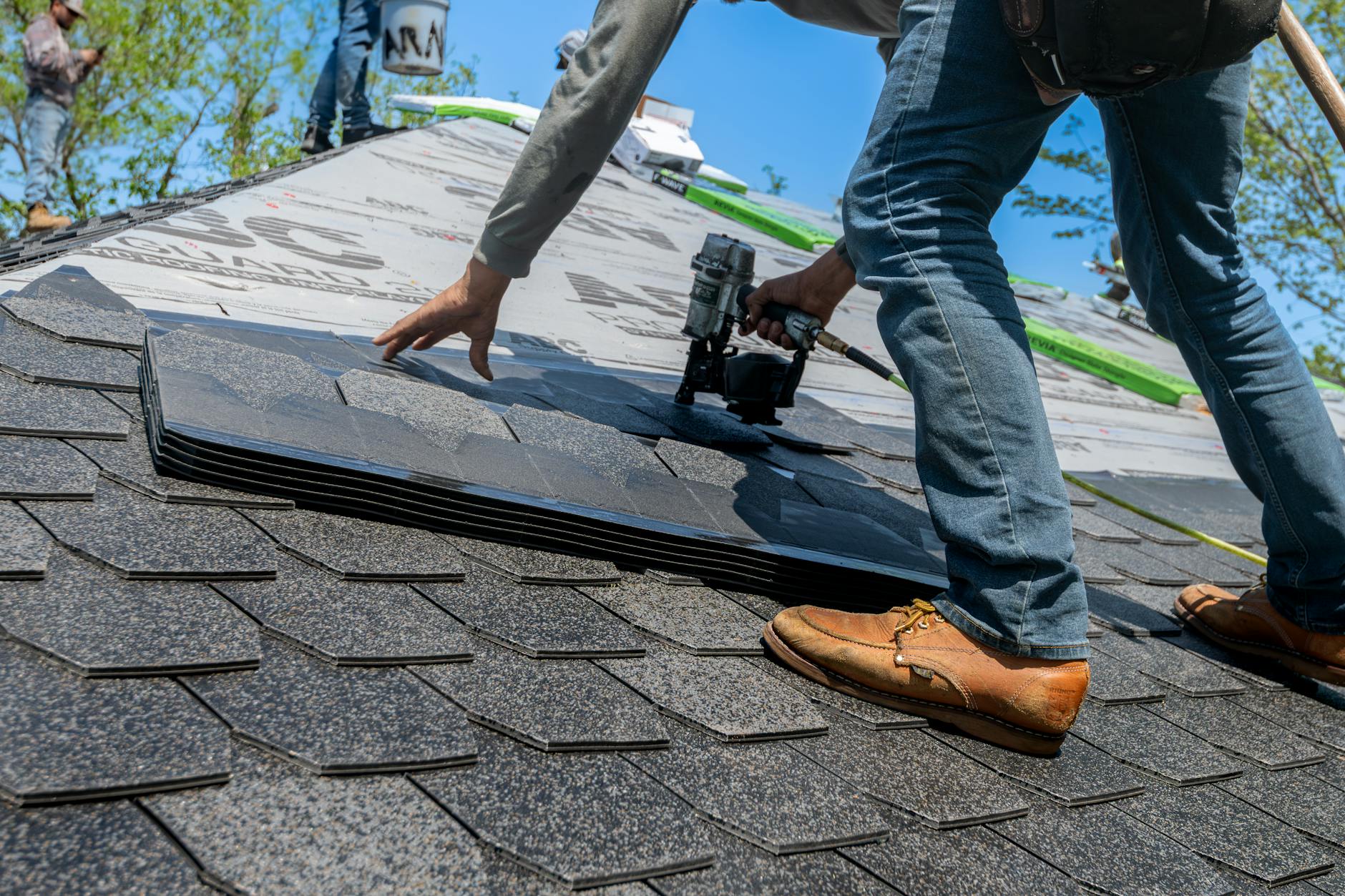A Prime Ridge Roofing crew member inspecting a tile roof on a Summerlin South home, pointing out a potential issue to the homeowner.