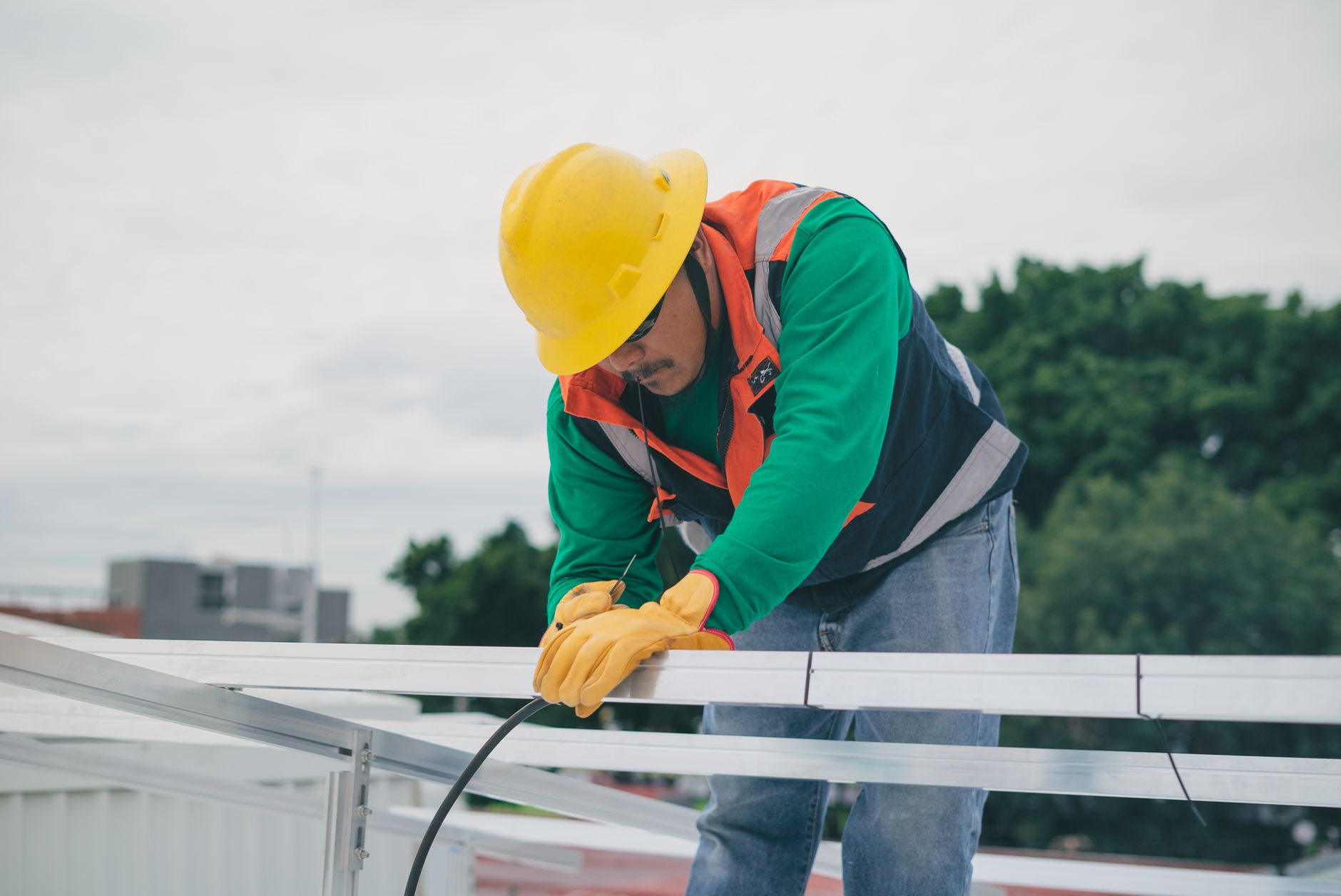 A skilled roofing technician in Whitney, Nevada, inspecting a tile roof for cracked or slipped tiles, demonstrating attention to detail.