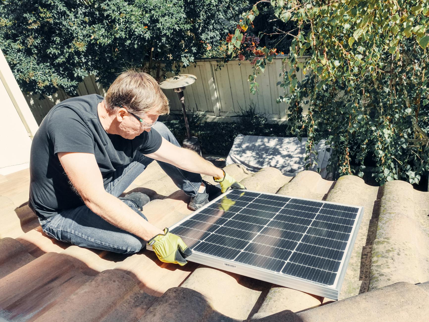 A Prime Ridge Roofing team member discussing roof material options with a homeowner in a Las Vegas backyard.